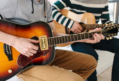 Learning to play the guitar. Music education and extra-curricular lessons.